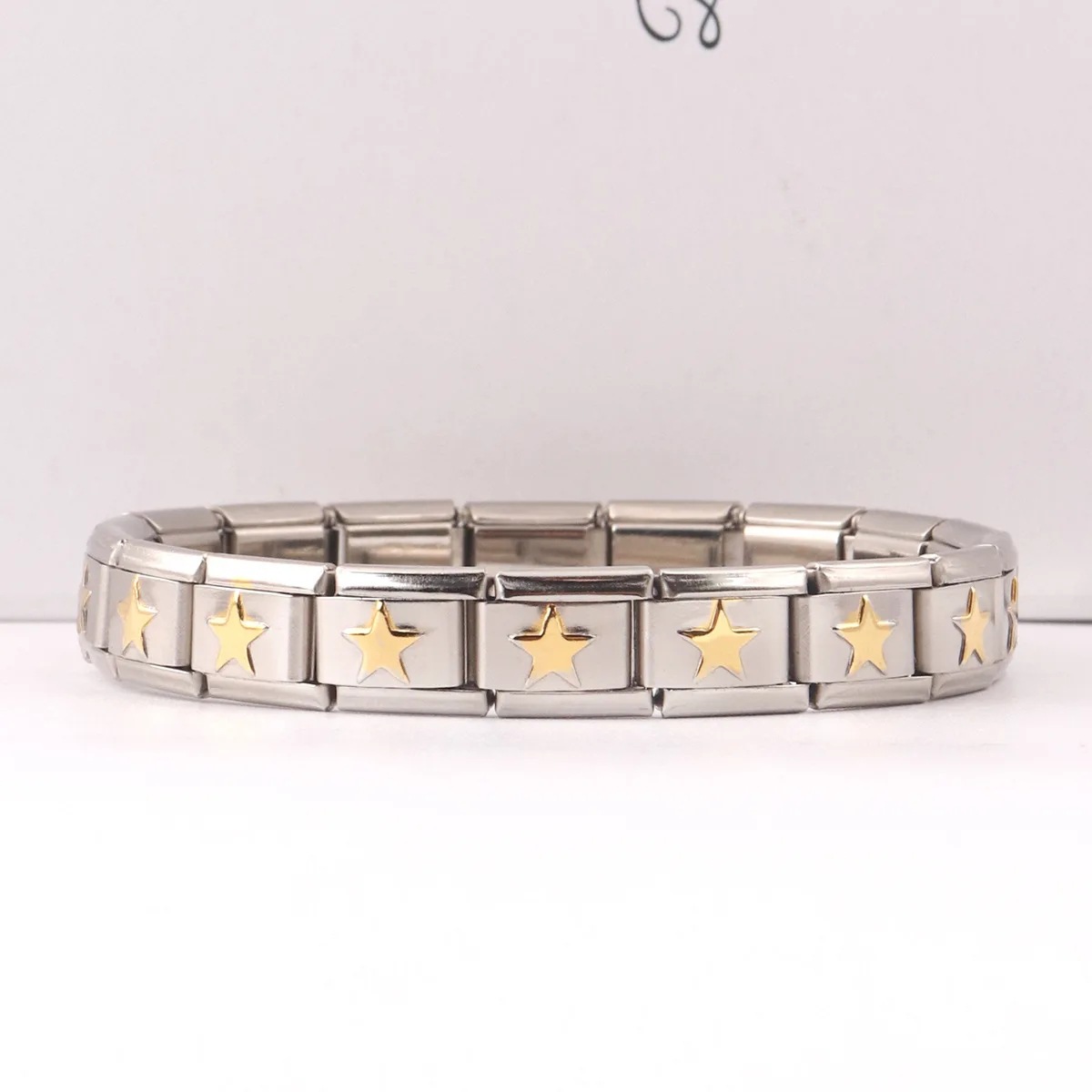 Italian Charms patterned modular bracelet with square elastic titanium steel strap.