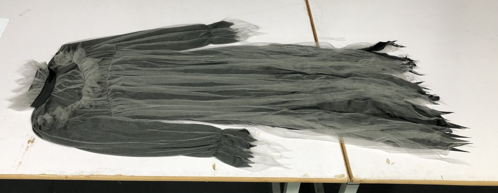 Halloween costume featuring a spooky, ghostly bride, a long, irregularly shaped tulle skirt, perfect for stage performances.