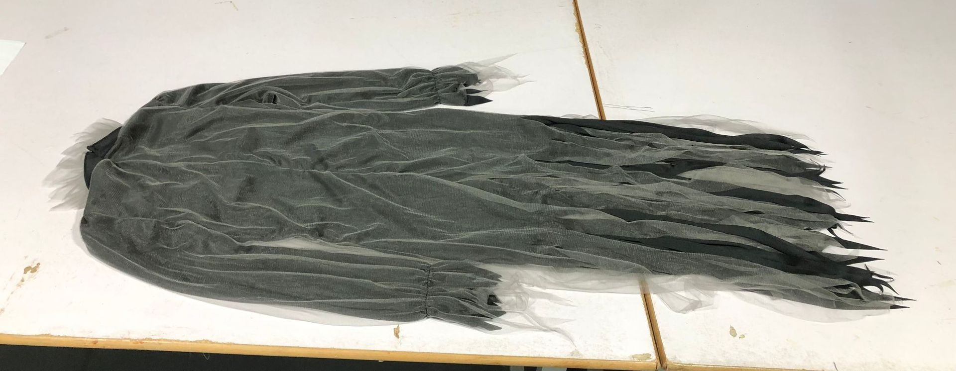 Halloween costume featuring a spooky, ghostly bride, a long, irregularly shaped tulle skirt, perfect for stage performances.