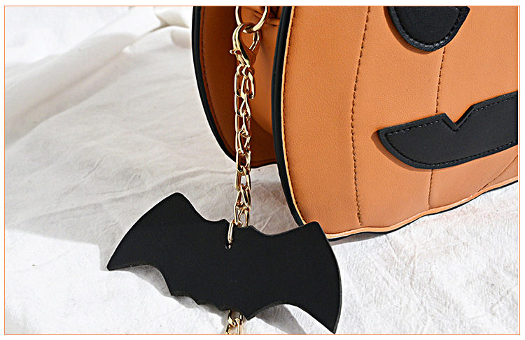 Halloween costume accessories: fun orange Jack-o'-lantern, smiling pumpkin head, bat crossbody bag.